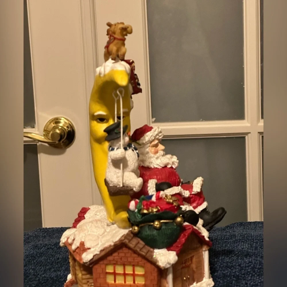 Sleepy Santa rests while a snow buddy swings. Missing bottom